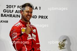 Race winner Sebastian Vettel (GER) Ferrari celebrates on the podium. 16.04.2017. Formula 1 World Championship, Rd 3, Bahrain Grand Prix, Sakhir, Bahrain, Race Day.