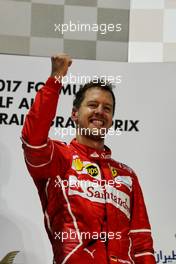 Race winner Sebastian Vettel (GER) Ferrari celebrates on the podium. 16.04.2017. Formula 1 World Championship, Rd 3, Bahrain Grand Prix, Sakhir, Bahrain, Race Day.