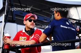 (L to R): Sebastian Vettel (GER) Ferrari with Pascal Wehrlein (GER) Sauber F1 Team, on the drivers parade. 16.04.2017. Formula 1 World Championship, Rd 3, Bahrain Grand Prix, Sakhir, Bahrain, Race Day.