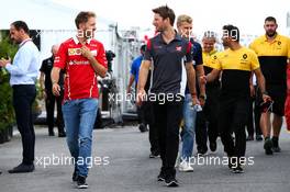 (L to R): Sebastian Vettel (GER) Ferrari with Romain Grosjean (FRA) Haas F1 Team. 09.06.2017. Formula 1 World Championship, Rd 7, Canadian Grand Prix, Montreal, Canada, Practice Day.