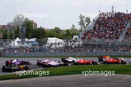 Sebastian Vettel (GER) Ferrari SF70H and Daniel Ricciardo (AUS) Red Bull Racing RB13 at the start of the race. 11.06.2017. Formula 1 World Championship, Rd 7, Canadian Grand Prix, Montreal, Canada, Race Day.