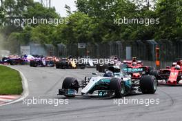 Valtteri Bottas (FIN) Mercedes AMG F1 W08 at the start of the race as Carlos Sainz Jr (ESP) Scuderia Toro Rosso STR12 crashes. 11.06.2017. Formula 1 World Championship, Rd 7, Canadian Grand Prix, Montreal, Canada, Race Day.
