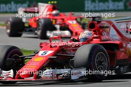 Sebastian Vettel (GER) Scuderia Ferrari andKimi Raikkonen (FIN) Scuderia Ferrari  11.06.2017. Formula 1 World Championship, Rd 7, Canadian Grand Prix, Montreal, Canada, Race Day.