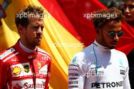 (L to R): Sebastian Vettel (GER) Ferrari and Lewis Hamilton (GBR) Mercedes AMG F1 as the grid observes the national anthem. 14.05.2017. Formula 1 World Championship, Rd 5, Spanish Grand Prix, Barcelona, Spain, Race Day.