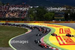 Sebastian Vettel (GER) Ferrari SF70H leads at the start of the race as Kimi Raikkonen (FIN) Ferrari SF70H and Max Verstappen (NLD) Red Bull Racing RB13 run wide. 14.05.2017. Formula 1 World Championship, Rd 5, Spanish Grand Prix, Barcelona, Spain, Race Day.