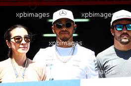 (L to R): Michelle Yeoh (MAL) with Lewis Hamilton (GBR) Mercedes AMG F1 and Fernando Alonso (ESP) McLaren. 14.05.2017. Formula 1 World Championship, Rd 5, Spanish Grand Prix, Barcelona, Spain, Race Day.