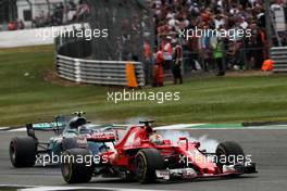 Sebastian Vettel (GER) Ferrari SF70H and Valtteri Bottas (FIN) Mercedes AMG F1 W08 battle for position. 16.07.2017. Formula 1 World Championship, Rd 10, British Grand Prix, Silverstone, England, Race Day.