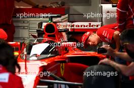 Kimi Raikkonen (FIN) Ferrari looks at the Shield cockpit cover on the Ferrari SF70H of Sebastian Vettel (GER) Ferrari. 13.07.2017. Formula 1 World Championship, Rd 10, British Grand Prix, Silverstone, England, Preparation Day.