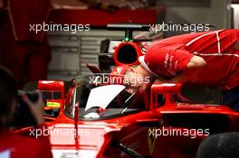 Kimi Raikkonen (FIN) Ferrari looks through a cockpit cover on the Ferrari SF70H of Sebastian Vettel (GER) Ferrari. 13.07.2017. Formula 1 World Championship, Rd 10, British Grand Prix, Silverstone, England, Preparation Day.