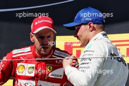 (L to R): Race winner Sebastian Vettel (GER) Ferrari on the podium with third placed Valtteri Bottas (FIN) Mercedes AMG F1. 30.07.2017. Formula 1 World Championship, Rd 11, Hungarian Grand Prix, Budapest, Hungary, Race Day.
