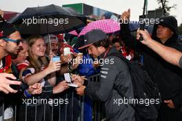 Fernando Alonso (ESP) McLaren signs autographs for the fans.