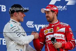 (L to R): Race winner Valtteri Bottas (FIN) Mercedes AMG F1 celebrates with Sebastian Vettel (GER) Ferrari on the podium. 30.04.2017. Formula 1 World Championship, Rd 4, Russian Grand Prix, Sochi Autodrom, Sochi, Russia, Race Day.