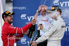 (L to R): Sebastian Vettel (GER) Ferrari celebrates his second position with race winner Valtteri Bottas (FIN) Mercedes AMG F1 on the podium. 30.04.2017. Formula 1 World Championship, Rd 4, Russian Grand Prix, Sochi Autodrom, Sochi, Russia, Race Day.