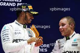 (L to R): Race winner Lewis Hamilton (GBR) Mercedes AMG F1 on the podium with third placed team mate Valtteri Bottas (FIN) Mercedes AMG F1. 17.09.2017. Formula 1 World Championship, Rd 14, Singapore Grand Prix, Marina Bay Street Circuit, Singapore, Race Day.