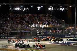 Sebastian Vettel (GER) Ferrari SF70H and Lewis Hamilton (GBR) Mercedes AMG F1 W08 leads at the start of the race as Kimi Raikkonen (FIN) Ferrari SF70H, Max Verstappen (NLD) Red Bull Racing RB13 and Fernando Alonso (ESP) McLaren MCL32, crash.                                17.09.2017. Formula 1 World Championship, Rd 14, Singapore Grand Prix, Marina Bay Street Circuit, Singapore, Race Day.