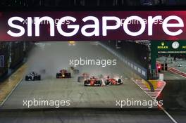 Sebastian Vettel (GER) Ferrari SF70H, Kimi Raikkonen (FIN) Ferrari SF70H, and Max Verstappen (NLD) Red Bull Racing RB13, crash at the start of the race. 17.09.2017. Formula 1 World Championship, Rd 14, Singapore Grand Prix, Marina Bay Street Circuit, Singapore, Race Day.