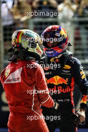 (L to R): Sebastian Vettel (GER) Ferrari celebrates his pole position with Max Verstappen (NLD) Red Bull Racing in qualifying parc ferme. 16.09.2017. Formula 1 World Championship, Rd 14, Singapore Grand Prix, Marina Bay Street Circuit, Singapore, Qualifying Day.